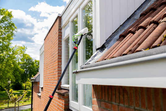 Using the washer-wiper set to clean a high window