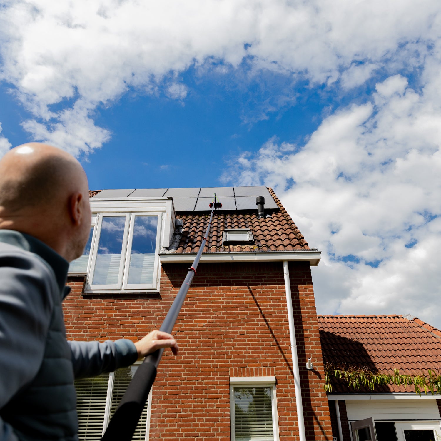 Cleaning solar panels using a standard brush shown from below