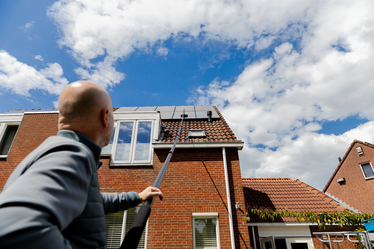 Cleaning solar panels using a standard brush shown from below