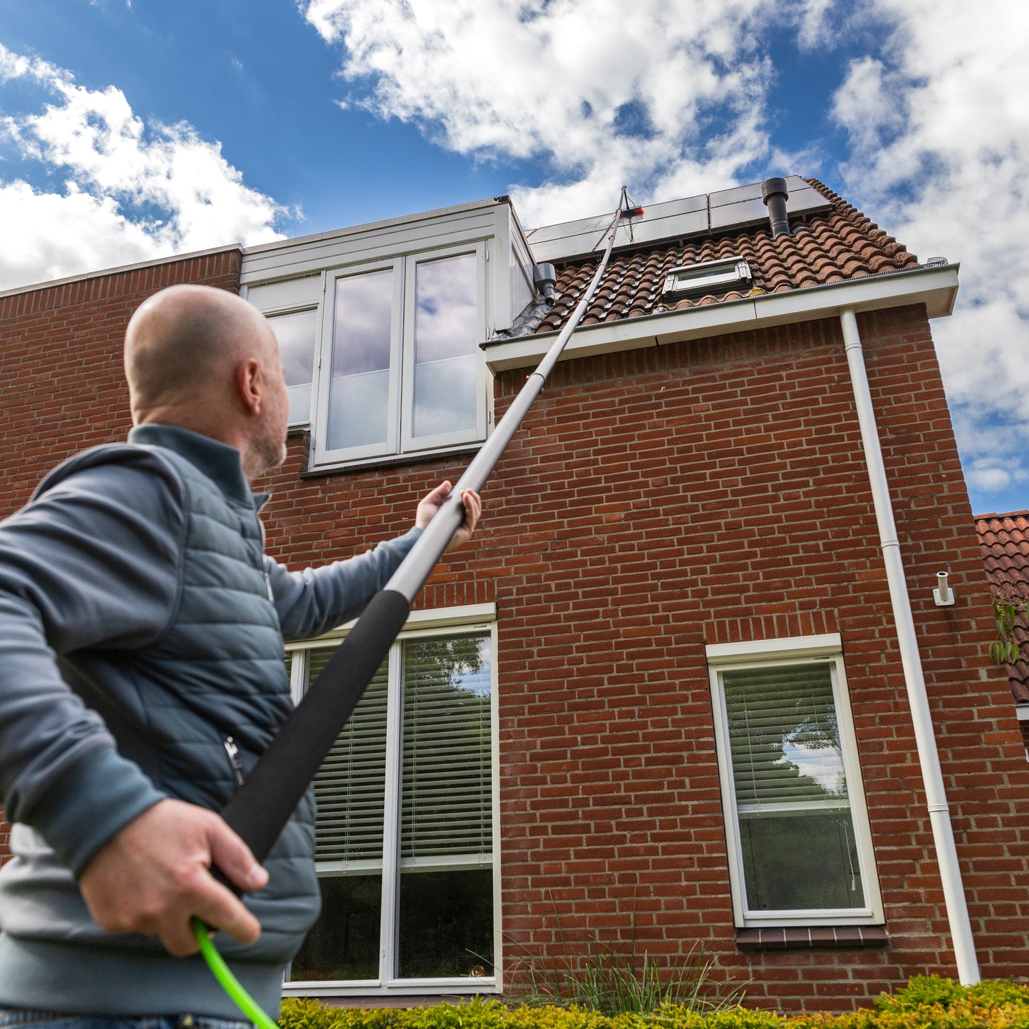 Cleaning solar panels using the standard brush from below