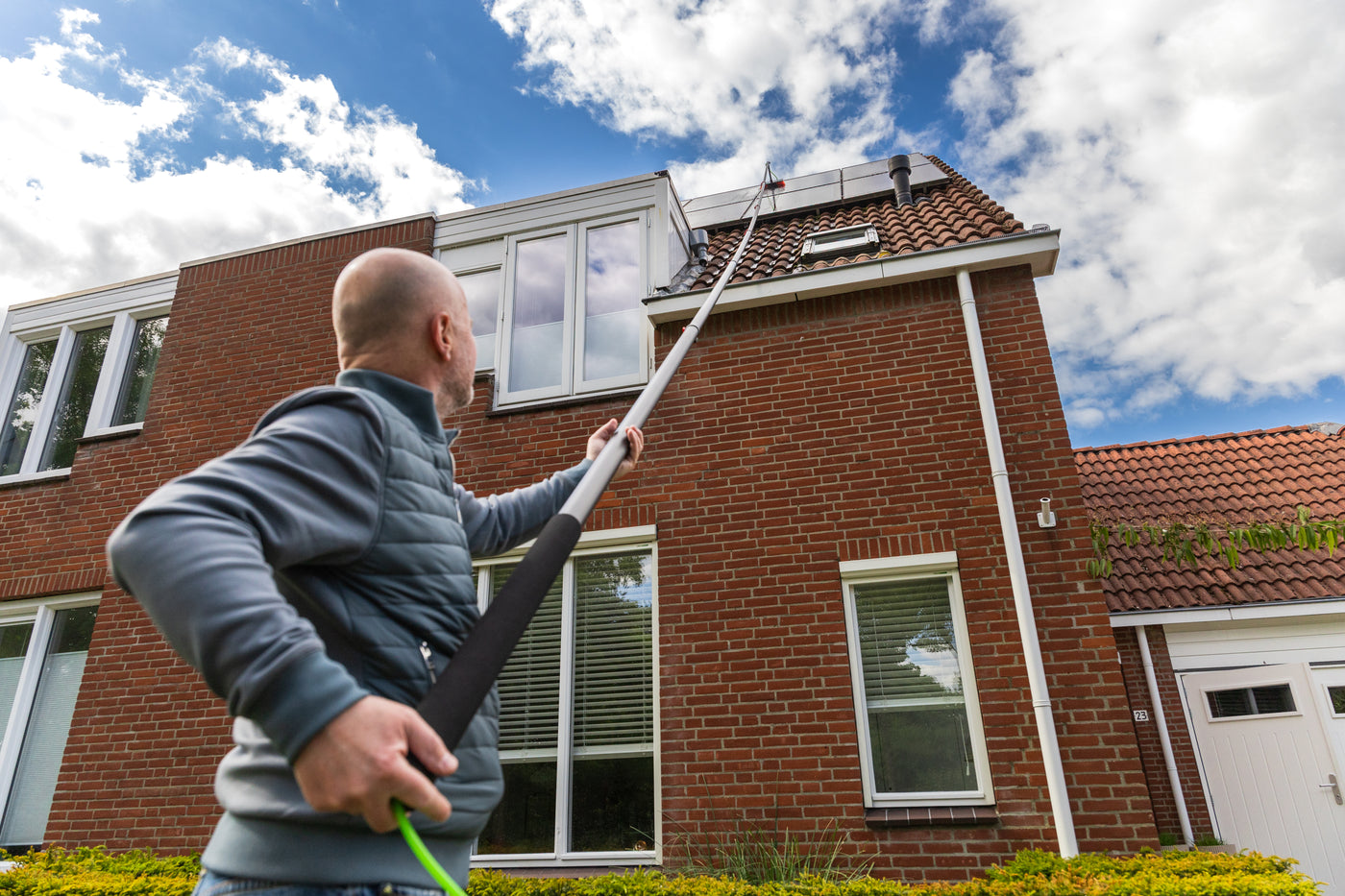 Cleaning solar panels using the standard brush from below