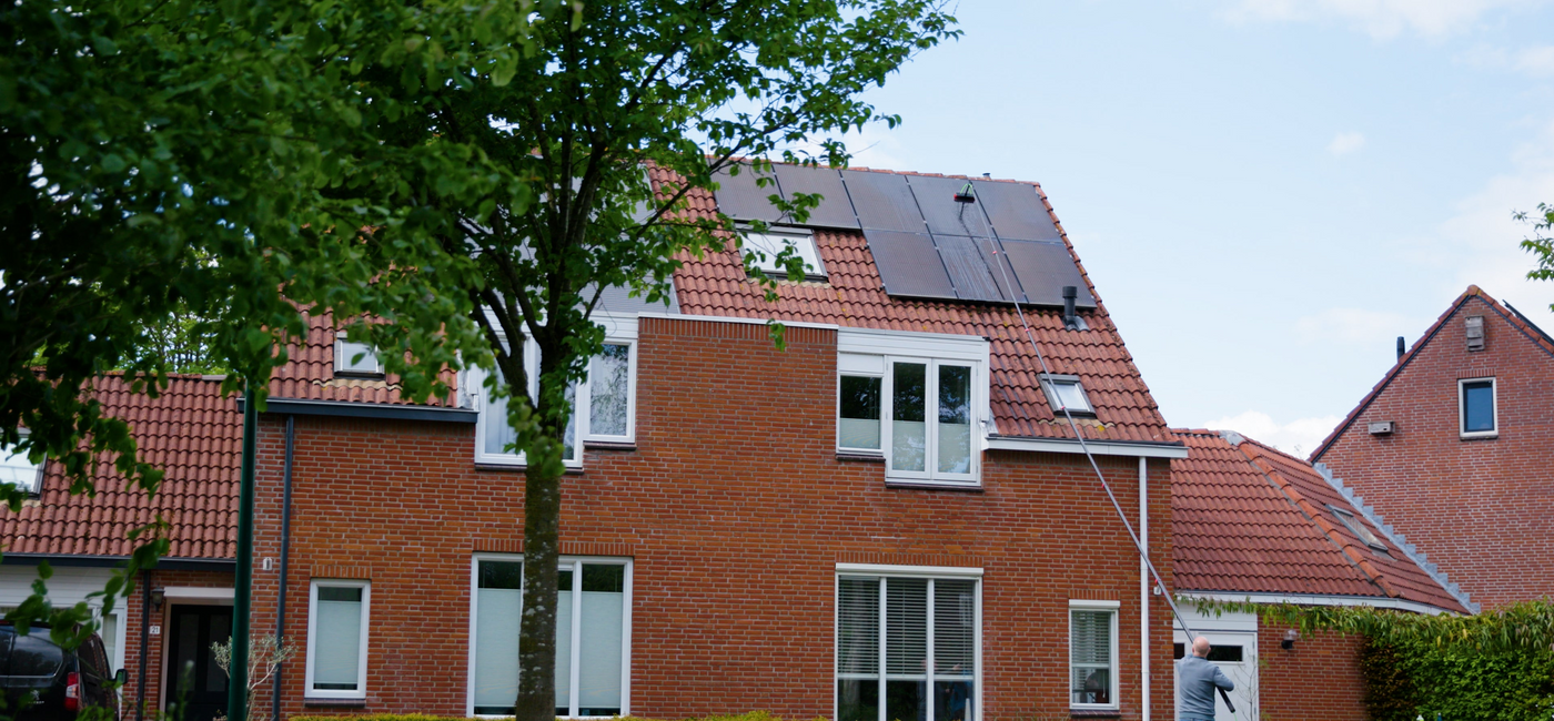 A man cleaning solar panels