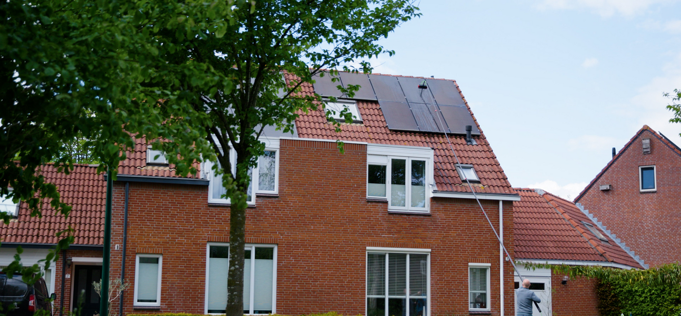 A man cleaning solar panels