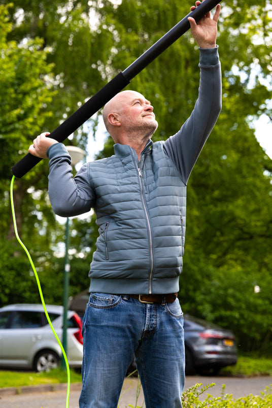 A man using a telescopic pole