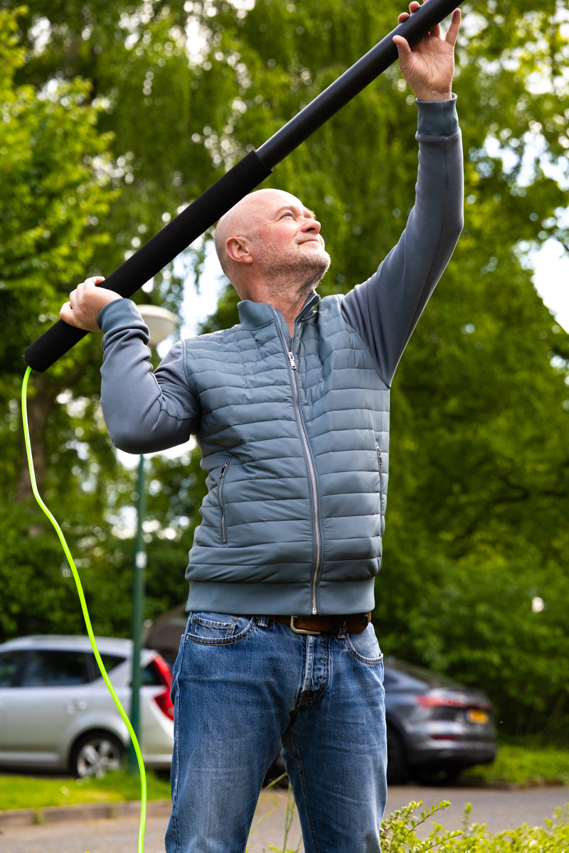 A man using a telescopic pole