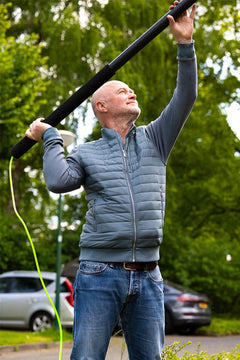 A man using a telescopic pole